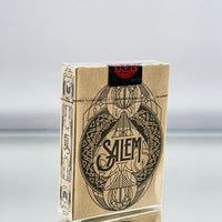 Salem playing cards packaging on a reflective surface with a gray background