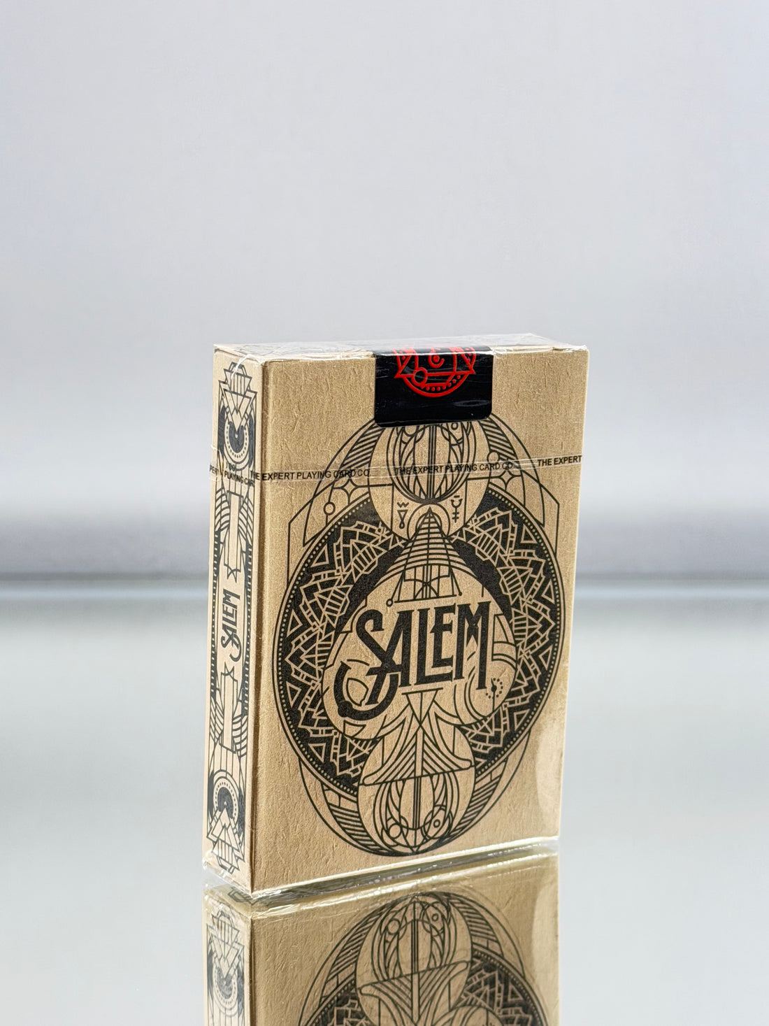 Salem playing cards packaging on a reflective surface with a gray background